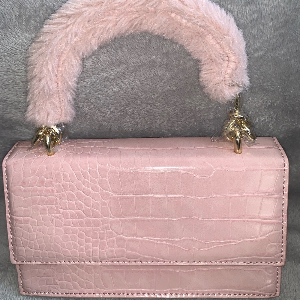 Pink mini bag with fur handle.